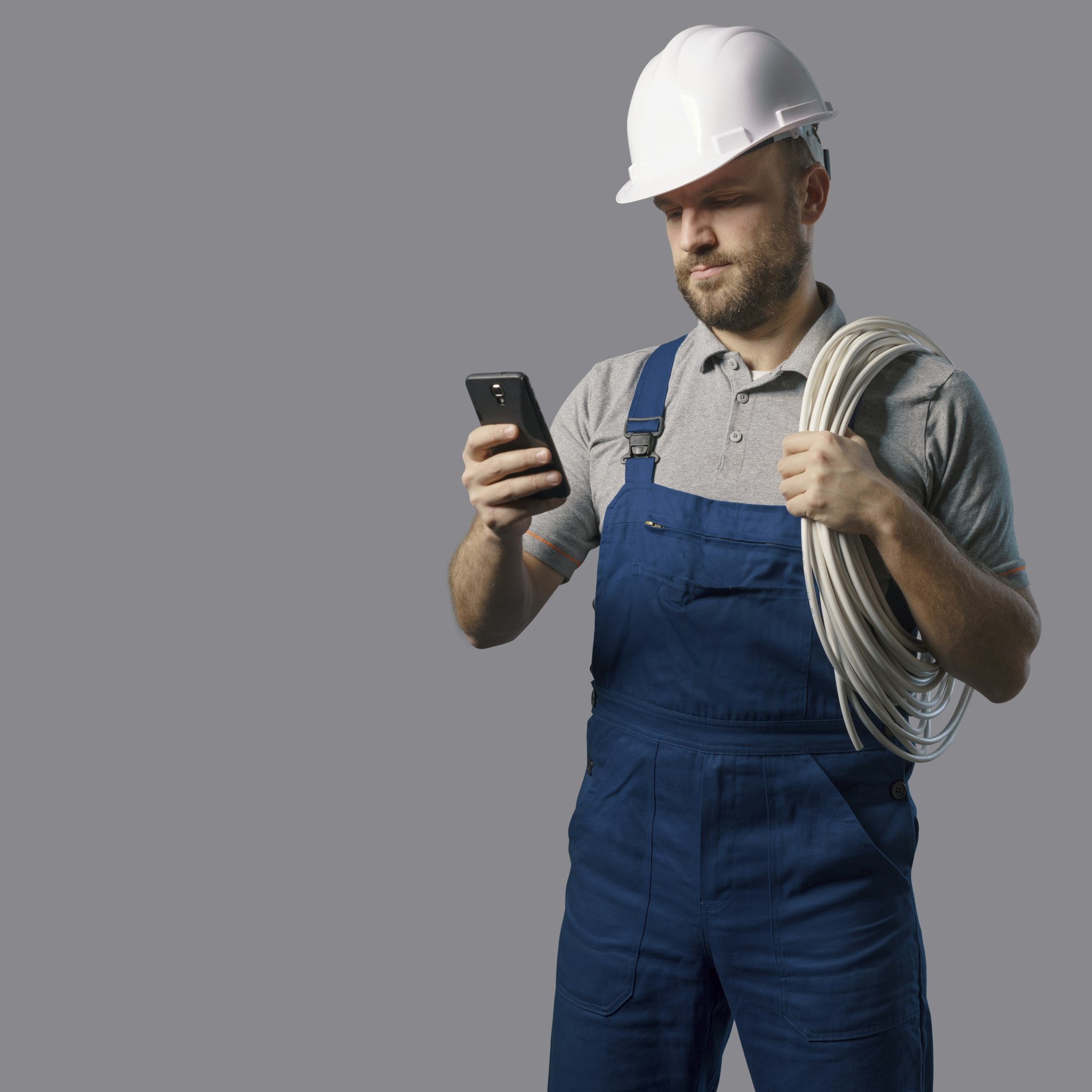 Professional electrician using a smartphone